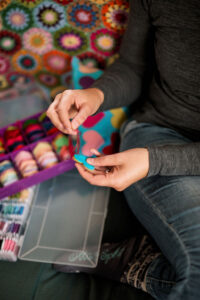 Hands stitching felt hearts